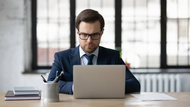 istock Serious Caucasian businessman use laptop in office 1248226355