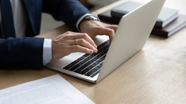 istock Close up of businessman typing using modern laptop 1248226386