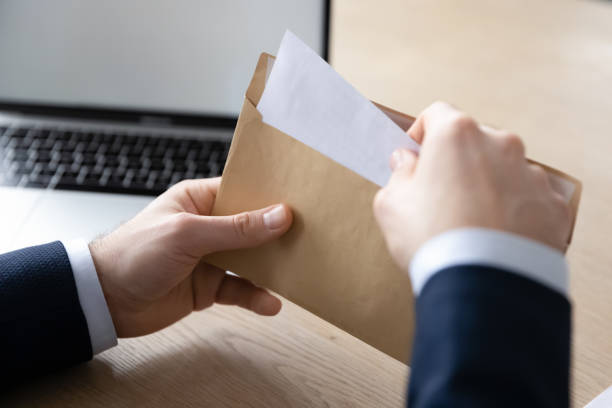 istock Close up male employee open envelope with letter 1248226429