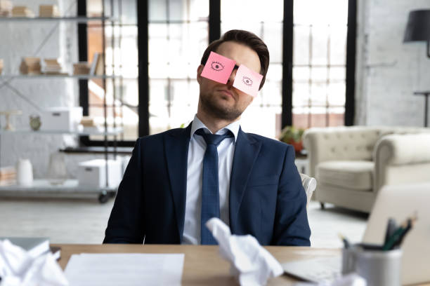istock Tired male employee fall asleep at workplace 1248226430