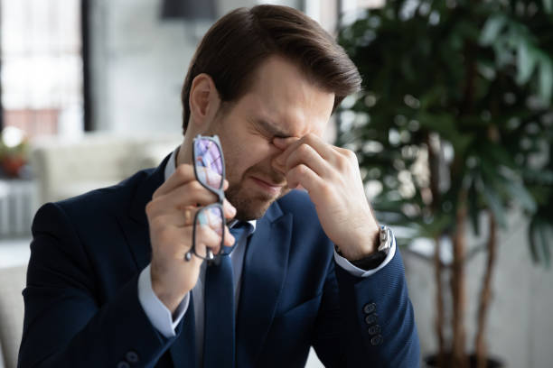 istock Tired businessman suffer blurry vision in office 1248226440