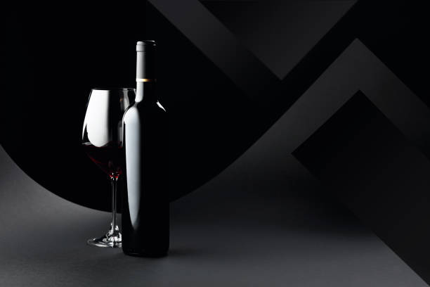 istock Bottle and glass of red wine on a dark background. 1248226614