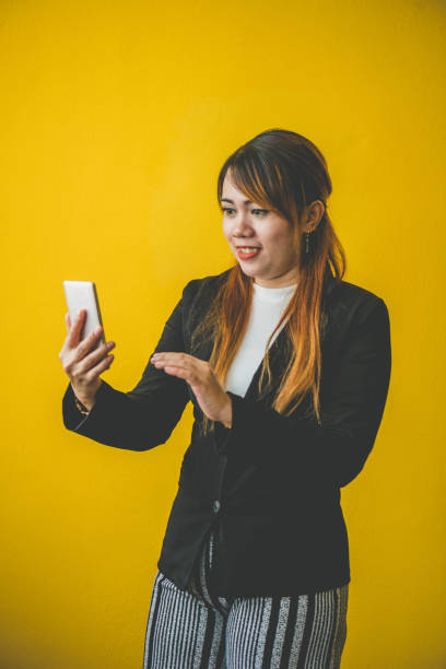 istock Asian woman taking selfie on yellow background 1248226623