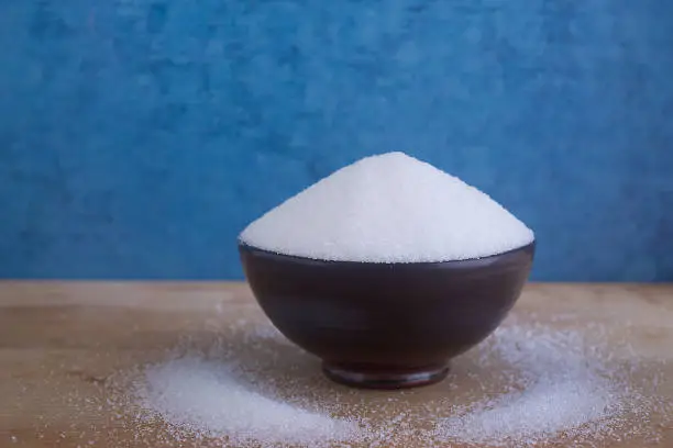 Close up Magnesium sulfate in bowl isolated on wooden background,fine Magnesium sulfate powder