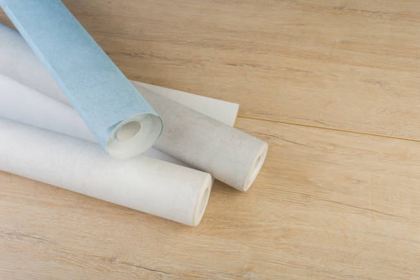 istock several rolls of multi-colored paper wallpaper on a wooden table 1248231926