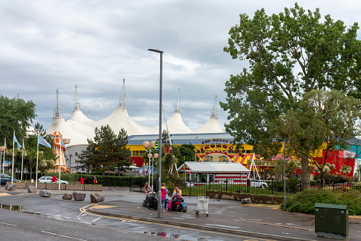 Scheveningen, the Netherlands - July 9 2019 View on wagons of the ferris wheel in Scheveningen. In the distance: the beach, the dunes and a hotel of Carlton