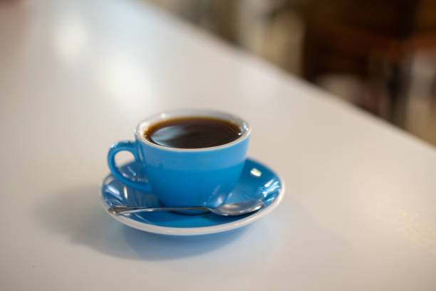 istock Black coffee in blue coffee cup on top of table 1248232309