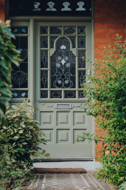 Traditional stained glass front door of an Edwardian house in London, UK, selective focus. London, UK - May 26, 2020:Traditional stained glass front door of an Edwardian house in London, selective focus. Edwardian houses promote simple design and an appreciation for the handmade. period property photos stock pictures, royalty-free photos & images