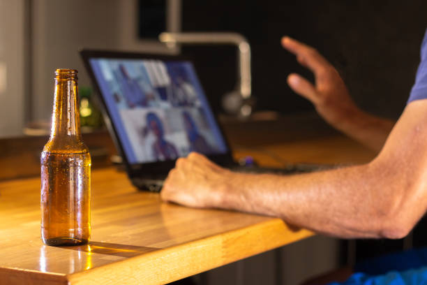 Video call with friends from home while having a beer stock photo