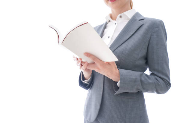 Business woman wearing a suit reading a book