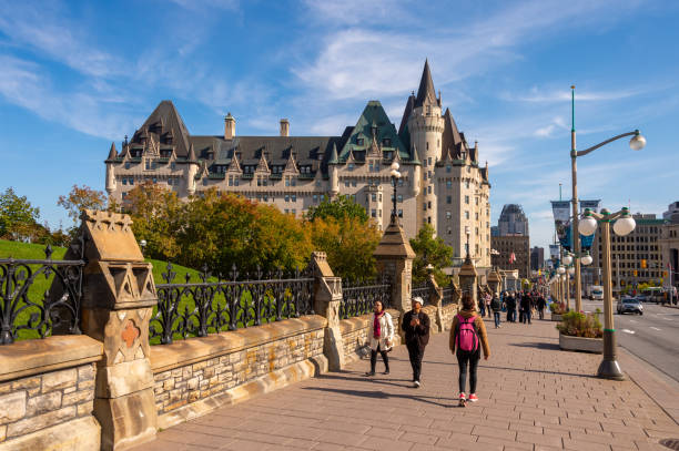 People walking on Wellington street Ottawa, CA - 9 October 2019:  People walking on Wellington street. Chateau Laurier in the distance. chateau laurier stock pictures, royalty-free photos & images