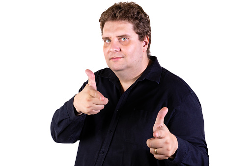 Young curvy man posing in a white background isolated excited pointing with forefingers away