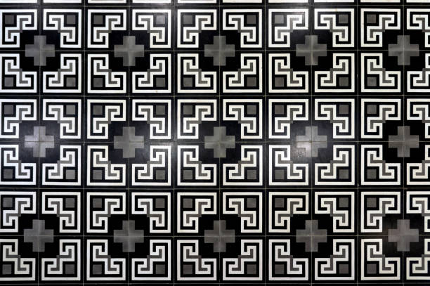 Mitla, Oaxaca, Mexico – November 11, 2025: Intricate interlocking geometric motifs fill a carved stone panel inside the Mitla ruins.
