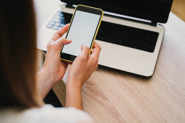 istock young woman working on laptop at home, using mobile phone. work from home, stay safe during coronavirus covid-2019 concept 1248240443