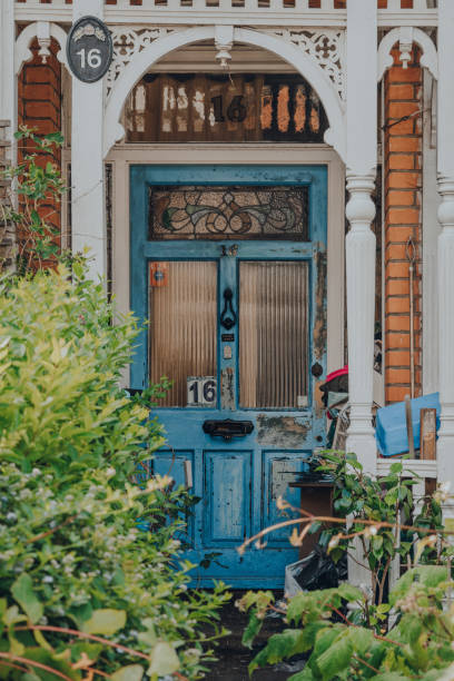 Blue decayed and aged front door of an Edwardian house in London, UK, selective focus. London, UK - May 26, 2020: Blue decayed and aged front door of an Edwardian house in London, selective focus. Edwardian style promotes simple design and an appreciation for the handmade. period property photos stock pictures, royalty-free photos & images