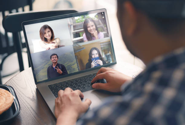 istock Young man talking about freelancer report in video conference. Asian team using laptop and tablet online meeting in video call.Working from coffee shop , Working remotely and Social isolation. 1248250790