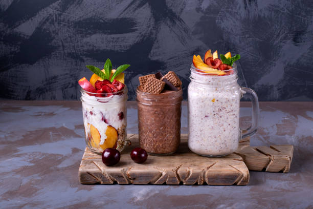 overnight oats assortment in glass jars - three different refrigerators imagens e fotografias de stock