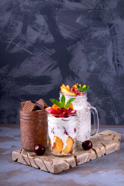 overnight oats assortment in glass jars - three different refrigerators imagens e fotografias de stock