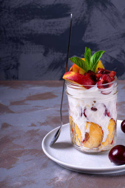 istock Overnight oats with nectarine, cherry, yogurt and milk in a glass jar 1248252375