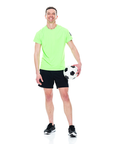 Professional caucasian football soccer player standing with ball isolated on white studio background. Concept of sport, movement, energy and dynamic, healthy lifestyle. Back view