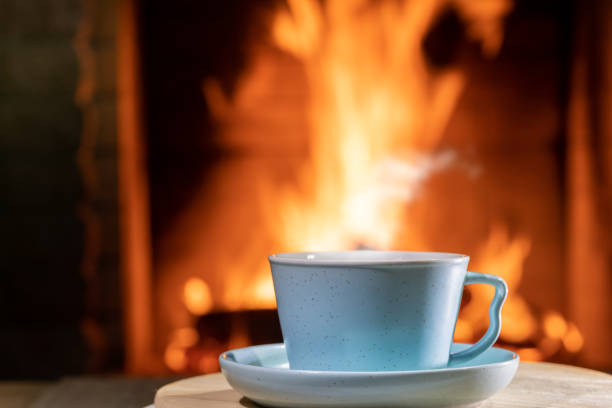 istock A cup of Tea before burning fireplace in a country house. 1248253167