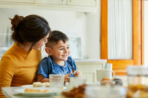 istock Happy mother enjoying breakfast with son at home 1248254303