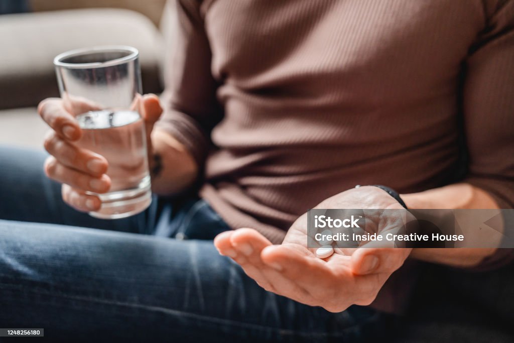 Close up of senior man taking medicines with water People, Virus, Senior, Mature, Healthcare and Medicine Taking Medicine Stock Photo