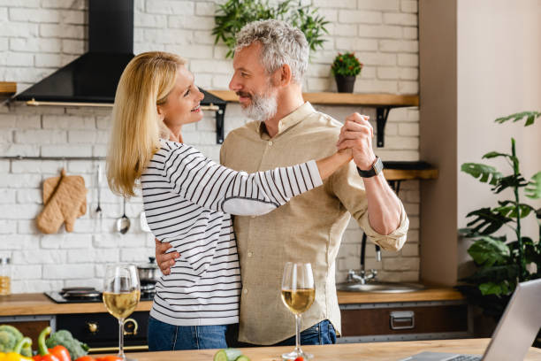 Middle aged couple dancing at home kitchen People, Senior Couple, Indoors, Family, Love-Emotion middle aged couple dancing stock pictures, royalty-free photos & images