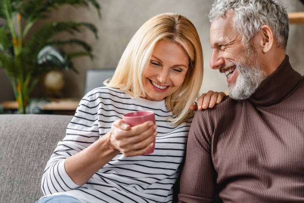 istock Happy mature couple laughing and drinking coffee while having fun at home 1248256631