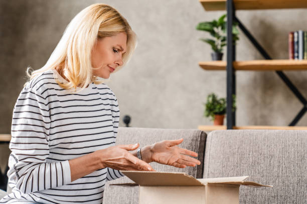 istock Middle aged woman being unhappy by her order when her shipping parcel came 1248256942