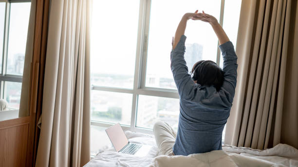 istock Businessman working with laptop on the bed 1248260343