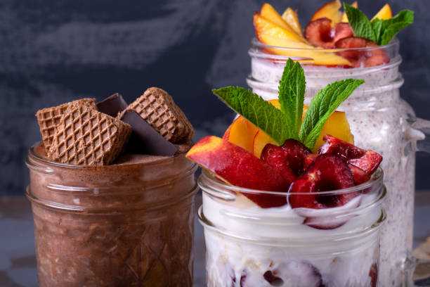 overnight oats assortment in glass jars - three different refrigerators imagens e fotografias de stock