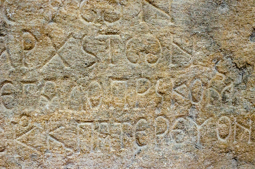 Stone vintage tablet with inscriptions as a background.