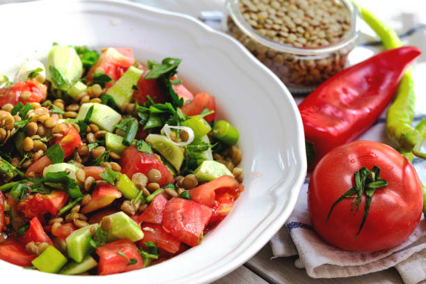 istock Plate with delicious lentils salad on wooden table 1248263920