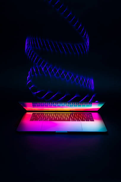 istock Isolated high tech open laptop with abstract vibrant color screen on a dark background. 1248263940