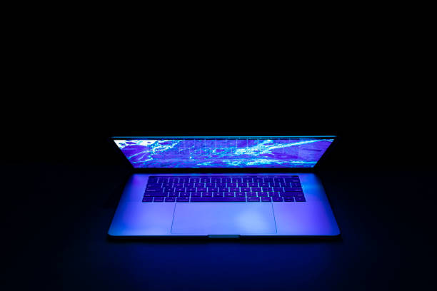 istock Isolated high tech open laptop with abstract vibrant blue color screen on a dark background. 1248264014