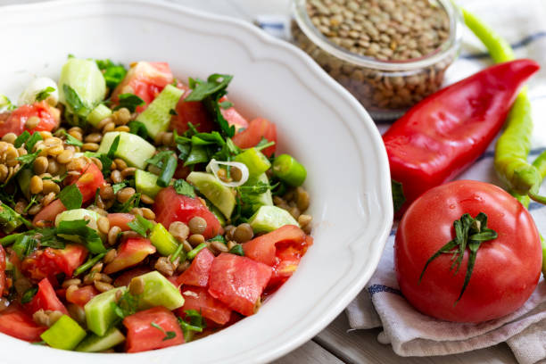 istock Plate with delicious lentils salad on wooden table 1248264175