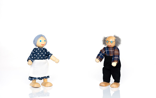 Miniature figures of grandparents. Social distancing in epidemic time concept.