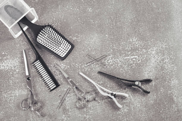 istock Hairdressing kit, scissors comb and clips on light grey background 1248268052