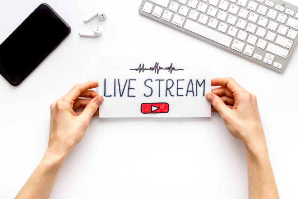 istock Live streaming web network concept. Female hands holding paper tablet. Top view 1248269531