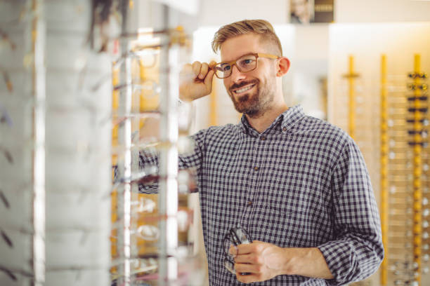 istock Young man buying eyeglasses at the optical store 1248271282