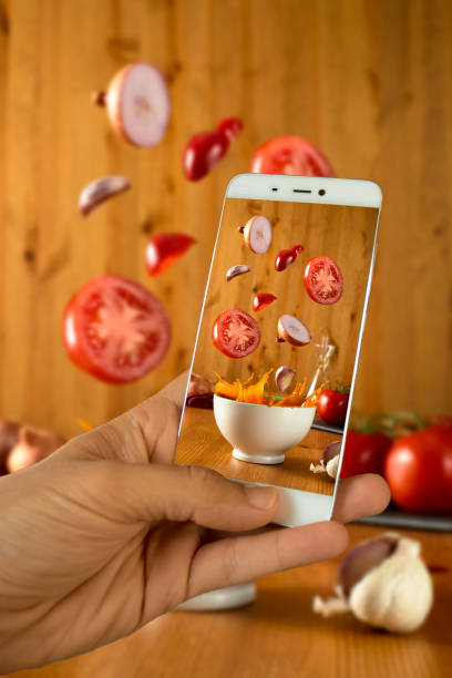 istock -hand with smartphone tomatoes falling in bowl of gazpacho splash selective focus 1248271325