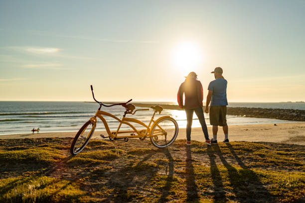 istock Young couple relax on the beach at sunrise 1248271462