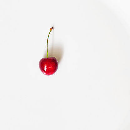 Top view of a cherry berry on a white background. Ripe cherrie texture. Space for text.