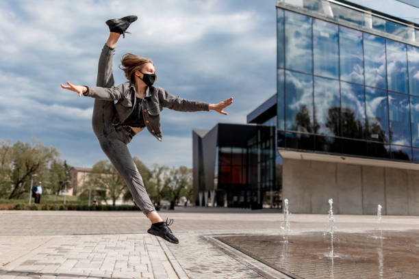 istock Modern dancer with black face mask outdoors 1248274369