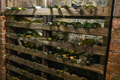Ancient wine rack with empty bottles of wine
