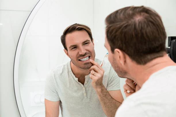 istock Young man brushing teeth in the bathroom 1248274969