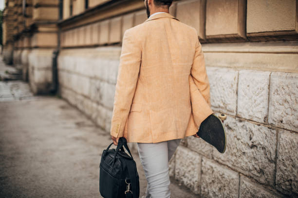 istock Modern young businessman with skateboard going to work 1248275510