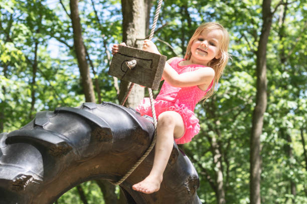 istock Girl On A Tire Swing 1 1248278288