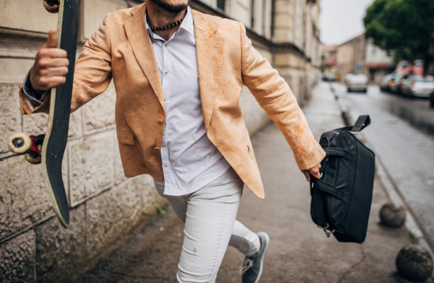 istock Young businessman with skateboard going to work on a rainy day 1248282444